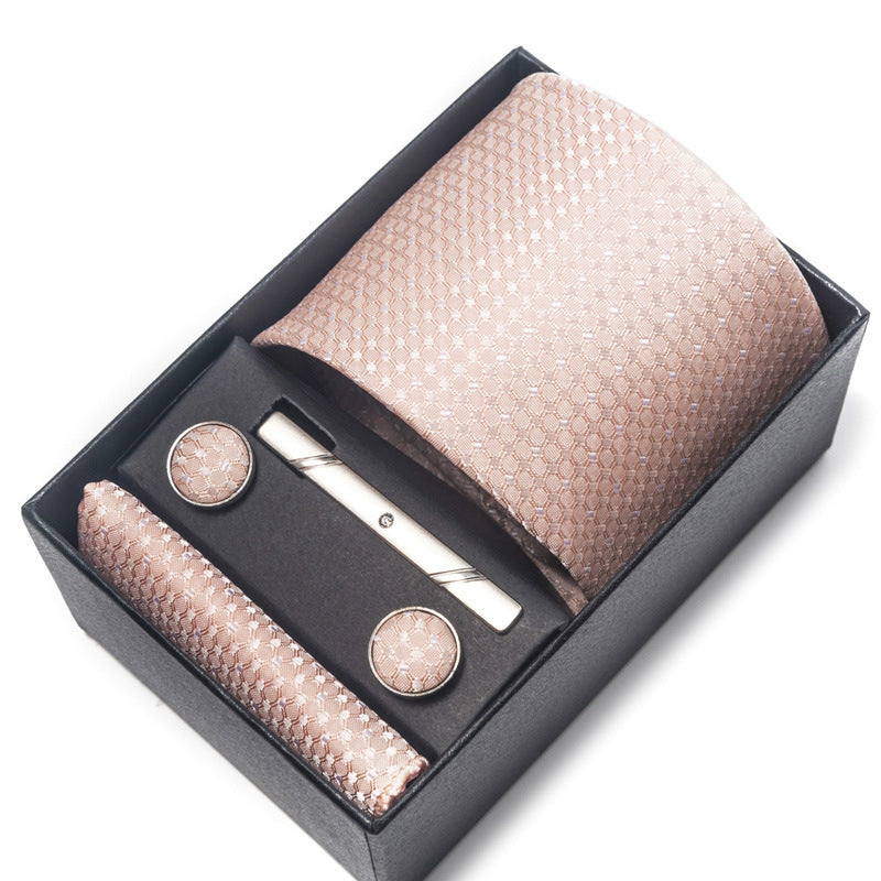 Tie set with tie, tie clip, and cufflinks in a black box on a white background