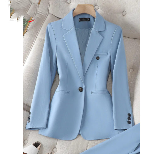 Light blue blazer on a hanger against a neutral background