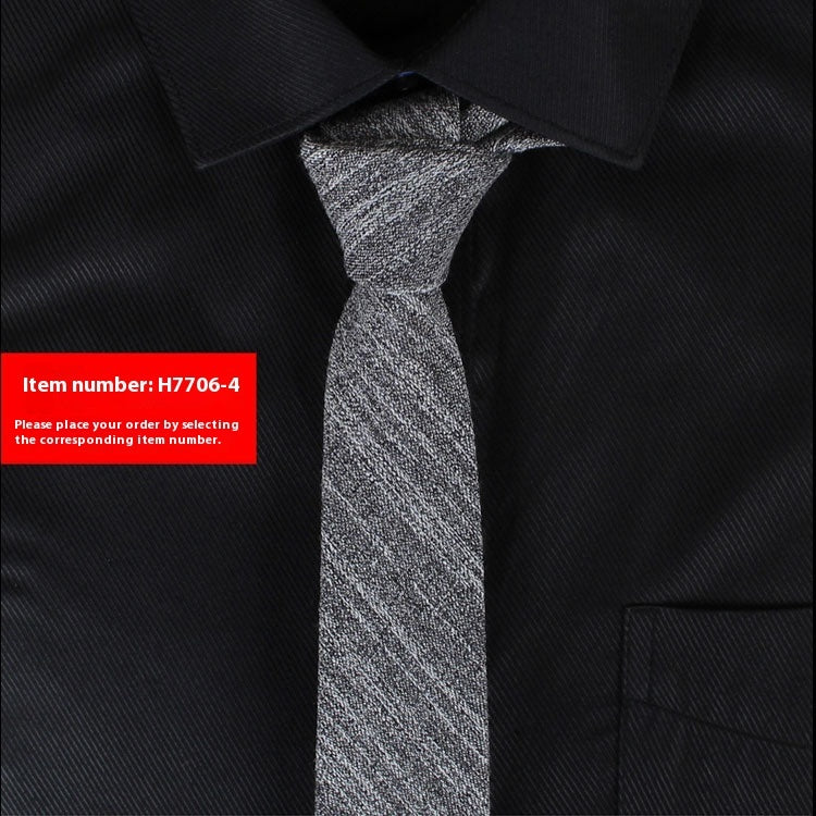Gray tie on a black shirt with a red item number label.
