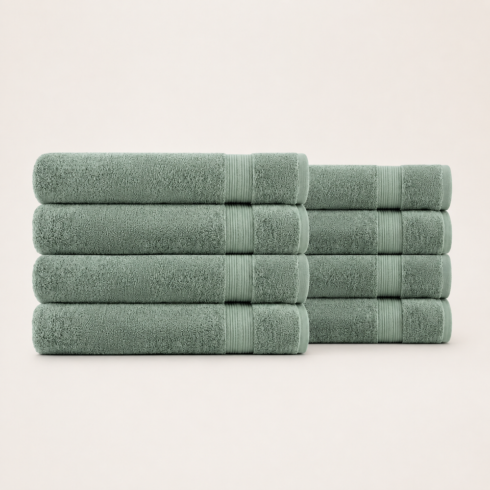 A set of eight folded towels in a muted sage green color, arranged in two stacks of four on a clean, light off-white background. Pure Cotton Bath Towel Set – Burgundy & Turquoise (74x33cm to 170x95cm)