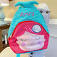 Mermaid-themed backpack with 'Avery' embroidered on it, held by a person.