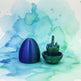 Blue and green 3D-printed object with a hand-like structure on a white background