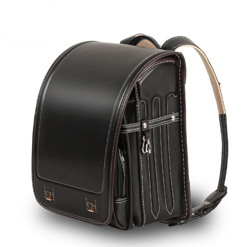 Black leather backpack with visible stitching on a white background