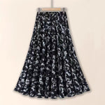 Black floral patterned skirt on a beige background
