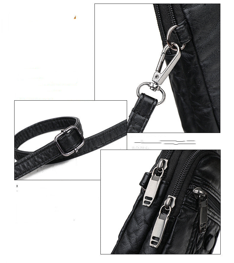 Close-up of a black bag with metal hardware including a clip and zippers.