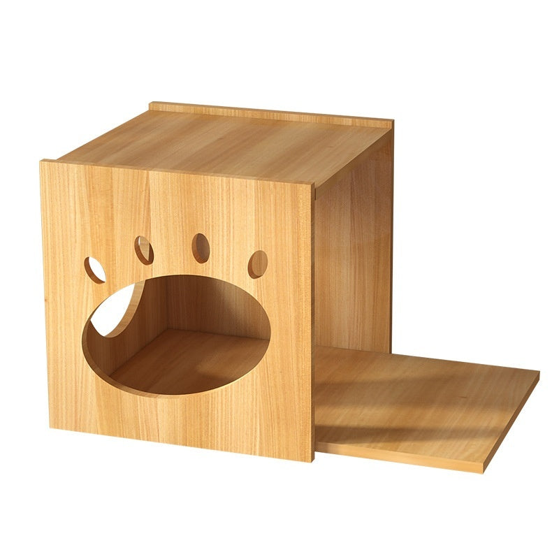 A light natural wood cat house with a paw print cutout entrance and a small ramp, shown on a plain white background.