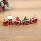 Decorative Christmas train set on a wooden surface