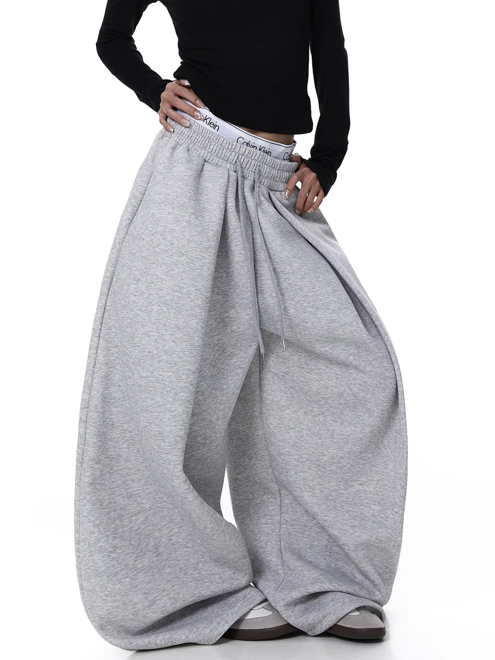 Gray wide-leg pants worn by a person on a white background