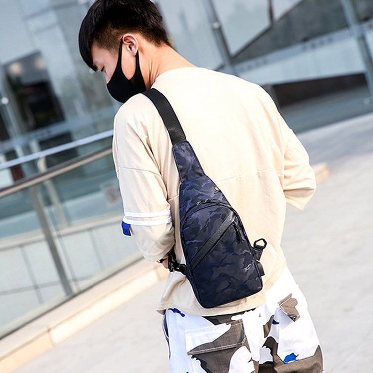 Person wearing a navy sling bag in an urban setting
