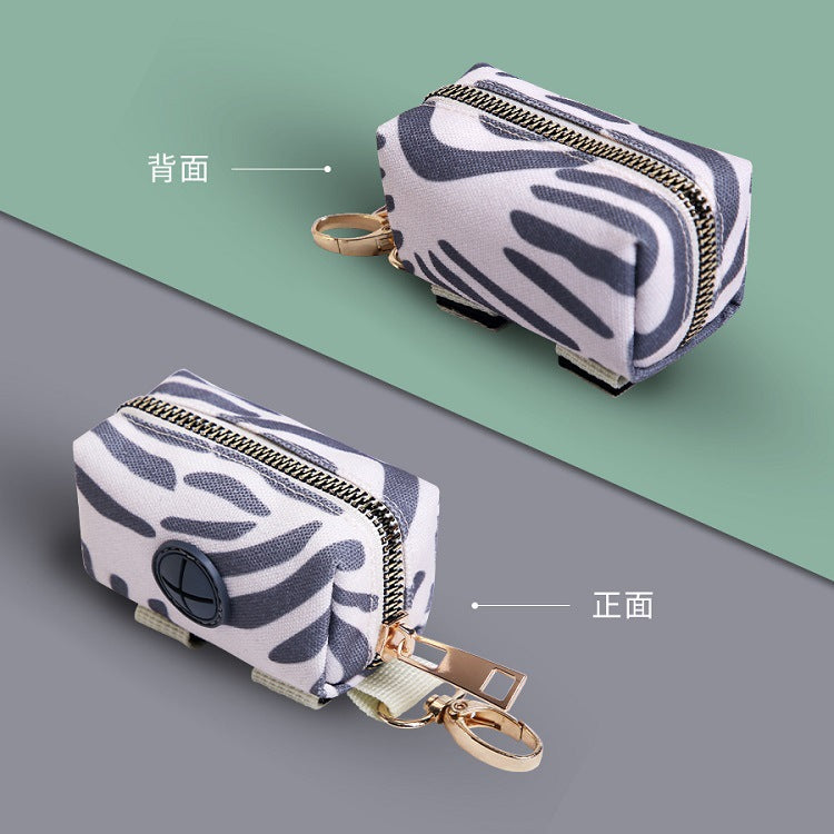 Two keychain pouches with zebra pattern on a green and gray background