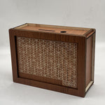 Wooden box with a printed grid and monetary value on a white background