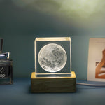 Moon-shaped crystal on a wooden base with a blurred background