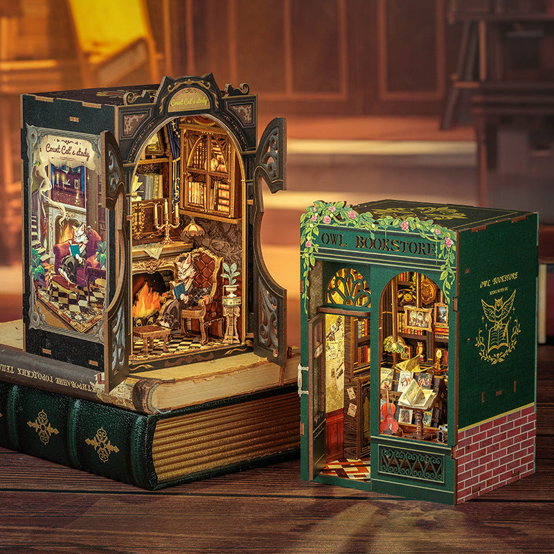 Two intricately designed book-shaped models on a wooden surface.
