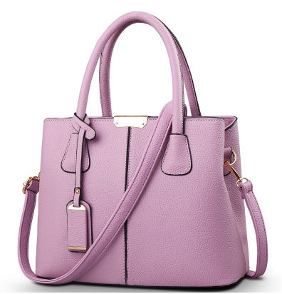 Purple handbag with a strap on a white background
