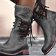 A pair of dark gray distressed leather lace-up ankle boots with brown laces and stacked wooden-look heels, shown worn on feet.