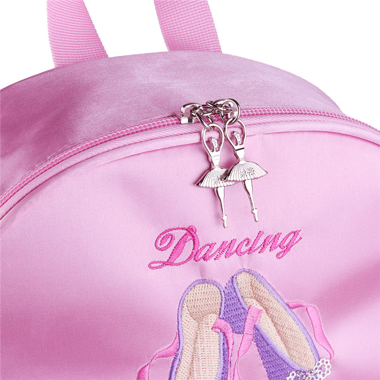 Pink backpack with 'Dancing' and ballet shoe design, featuring a ballerina charm.