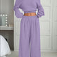 Person wearing a purple outfit in a bedroom setting