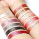 Set of lip swatches on a person's arm with color names and numbers.