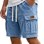 Blue cargo shorts with a white shirt worn by a person on a white background