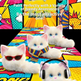 Three fluffy white toy cats posed on a bright comic-book style mat with bold text above reading 'Say No to the Same Old Thing Show Off Your Style.' The cats wear accessories: one pair of red sunglasses, one striped scarf, and one pair of black headphones.