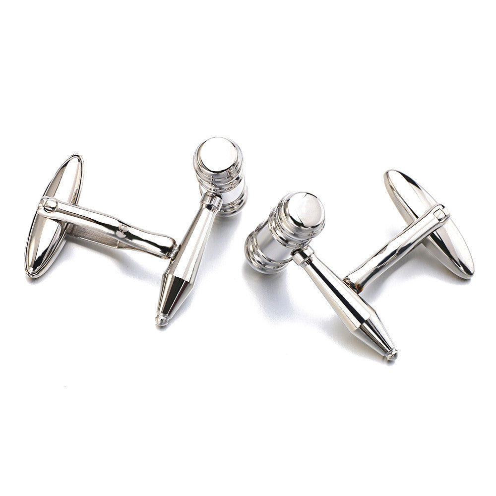Silver gavel cufflinks on a white background