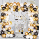 Balloon arch with gold, black, and white balloons in a decorated room.