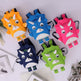 Five colorful dinosaur-shaped backpacks on a white surface.