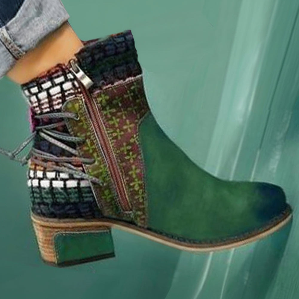 Green ankle boot with patterned side panel on a teal background