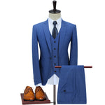 Blue suit on a mannequin with brown shoes on a white background
