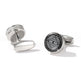 Silver cufflinks with intricate design on a white background