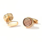 Gold cufflinks with intricate design on a white background