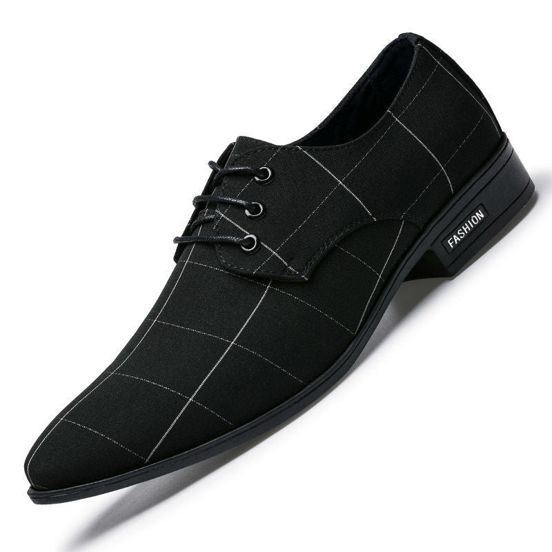 Black checkered dress shoe on a white background