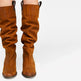 Brown knee-high boots on a white background