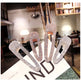 Set of four rhinestone hair clips on a magazine with a blurred indoor background