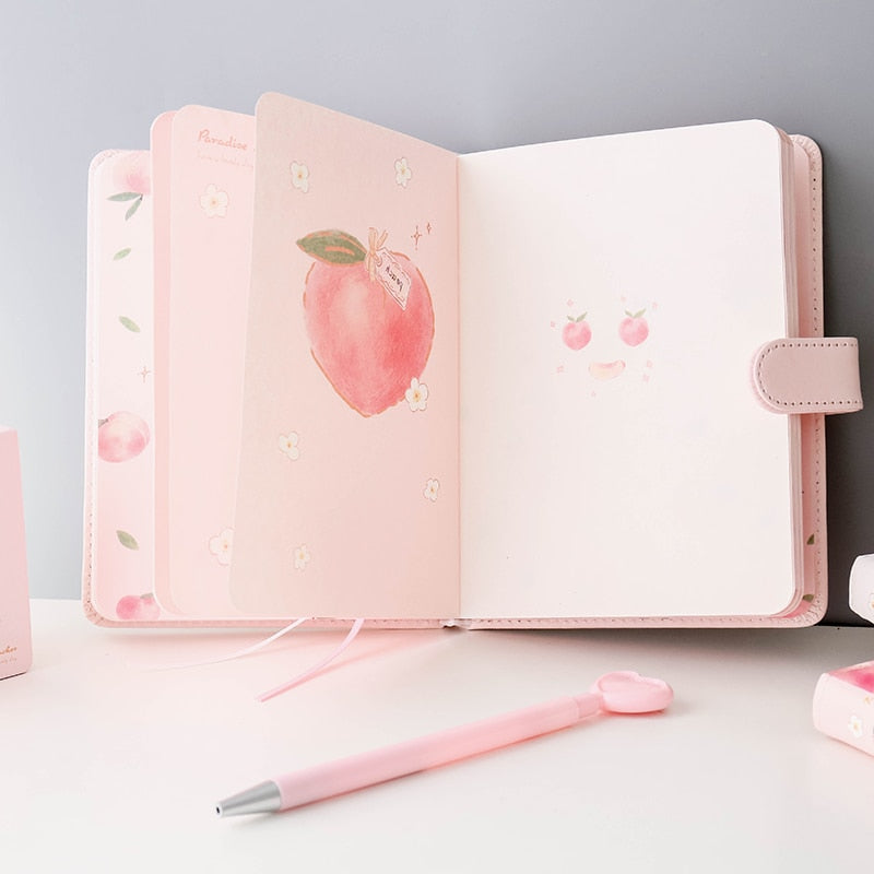 Pink planner with peach illustrations on a light gray background