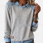 Gray sweatshirt with denim collar and cuffs worn by a person