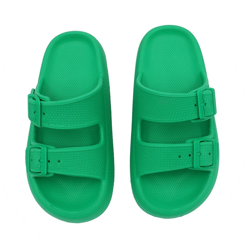 Green sandals with double straps on a white background