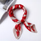 Red and beige patterned scarf on a white surface