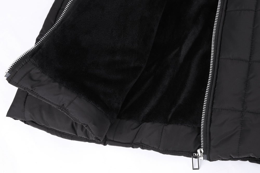 Close-up of a black puffer jacket with a zipper on a white background