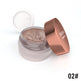 Open jar of glittery eye shadow with a rose gold lid on a white background