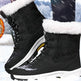 Black winter boots with white fur lining on a snowy background