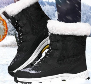 Black winter boots with white fur lining on a snowy background