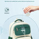 Backpack with water droplet being splashed on it, emphasizing water-repellent fabric.
