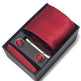 Red tie set with tie clip and cufflinks in a black box on a white background