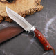 Knife with a wooden handle and leather sheath on a dark surface