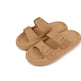 Pair of tan sandals with buckle straps on a white background