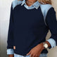 Navy sweater with denim collar and cuffs worn by a person.