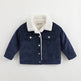 Navy blue corduroy jacket with white sherpa lining on a light gray background