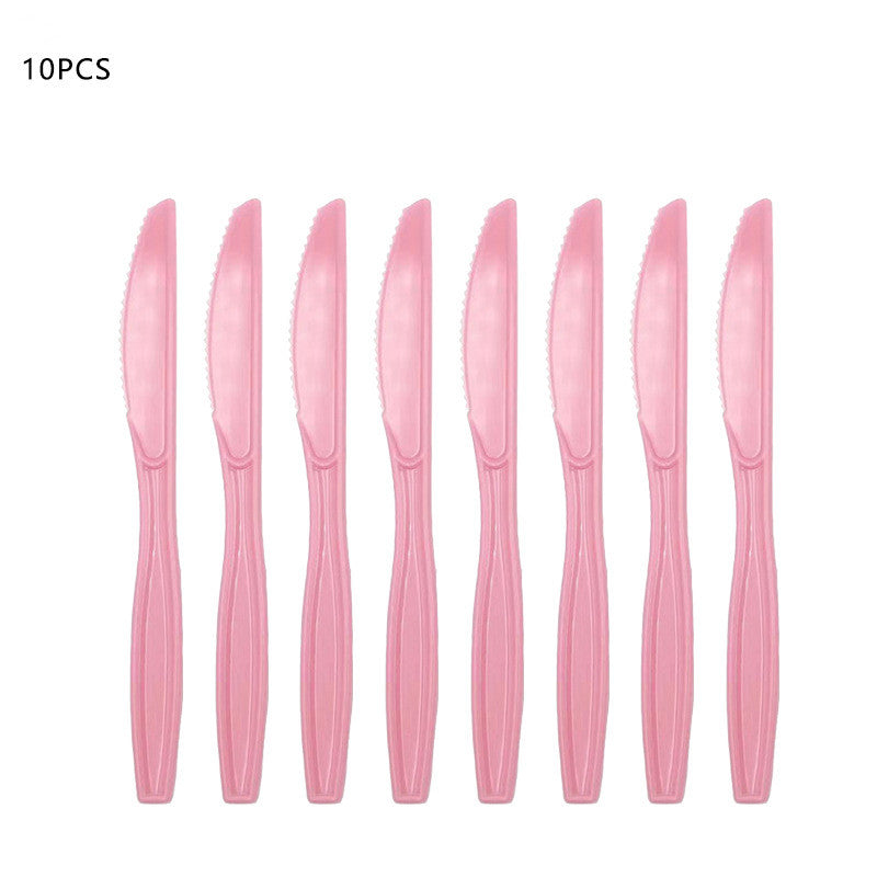 Set of 10 pink plastic knives on a white background