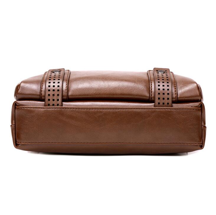 Brown leather clutch bag with perforated details on a white background